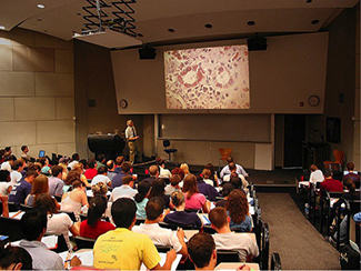 A photograph shows students in a classroom.